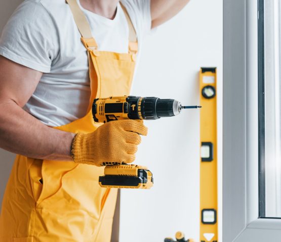 handyman-in-yellow-uniform-installs-new-window-by-2021-09-01-02-49-52-utc-min